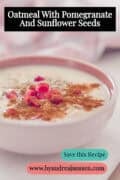 A pink bowl of oatmeal with pomegranate, sunflower seeds, and cinnamon. The text reads: "Oatmeal With Pomegranate And Sunflower Seeds."