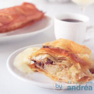 A square photo with a piece of apple pie, a cup and more apple pie in the background