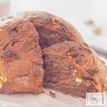 A square picture with chocolate bread, a slice cut out.