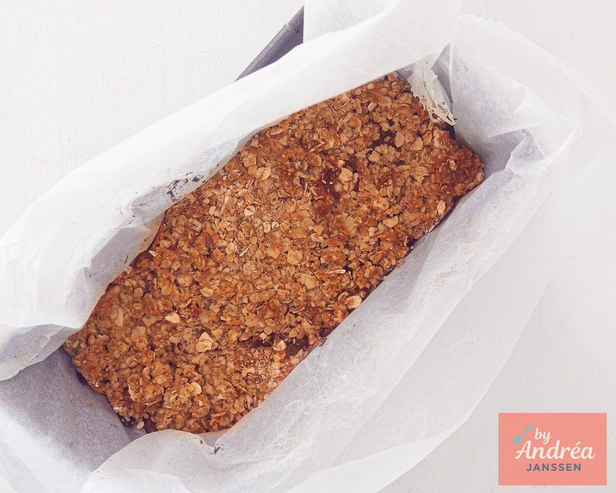 Date lemon oatmeal bar in a baking tin lined with baking paper