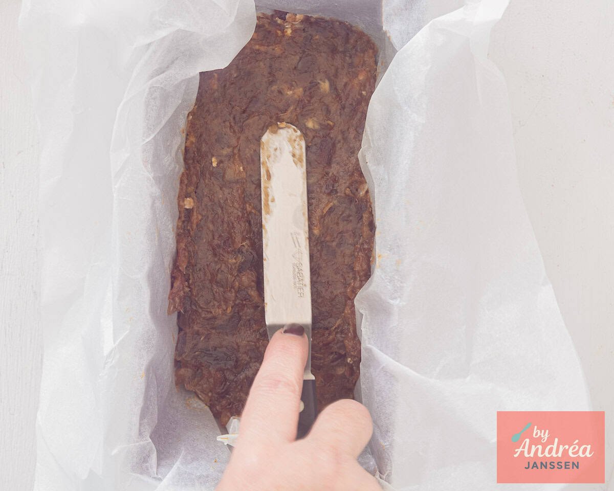 A baking tin on which the layer of date puree is spread