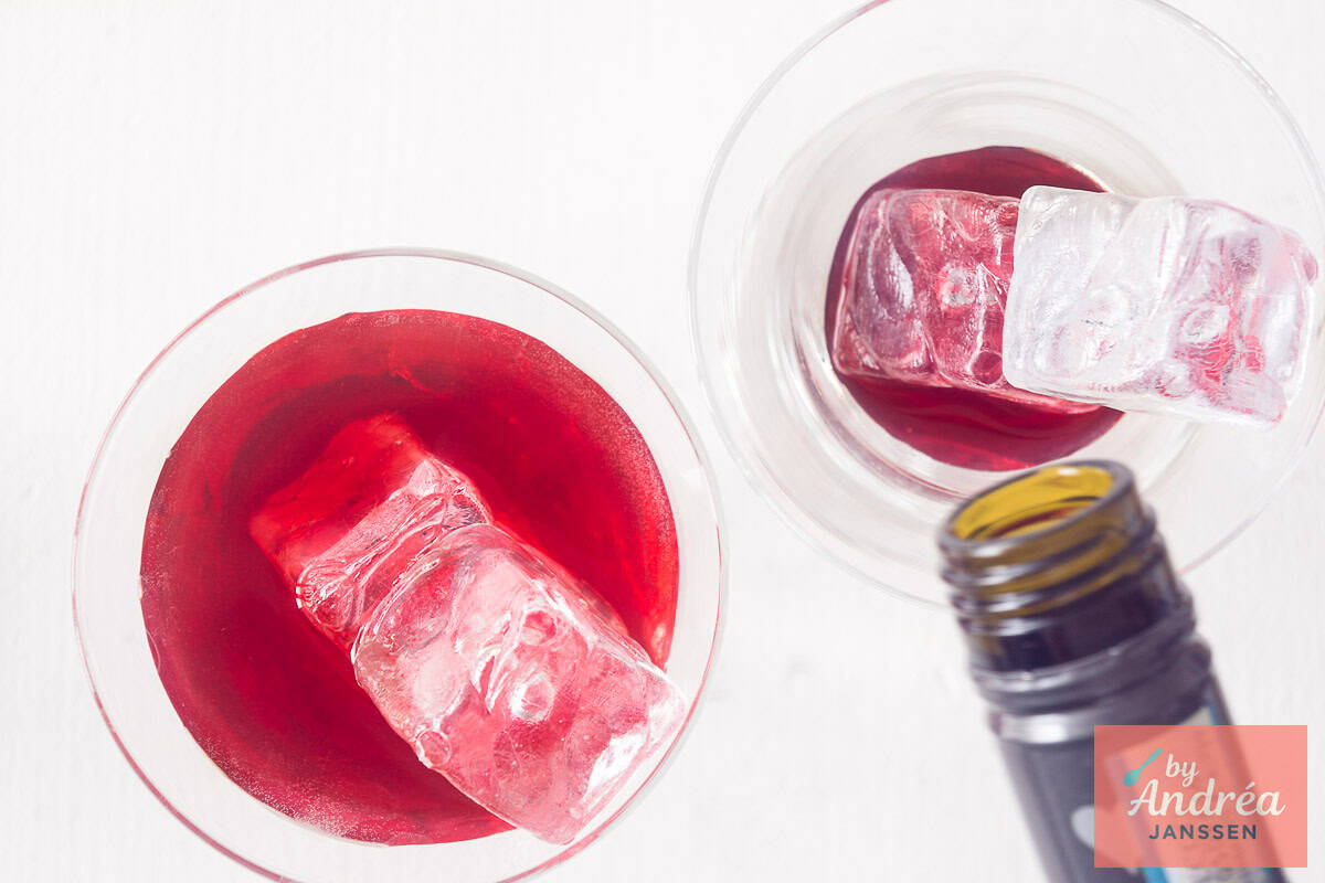 Prosecco is poured into a glass with cherry juice, vanilla and ice cubes