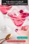Romantic Prosecco Cocktail with Cherries A text on top: Valentines Cocktail with Cherries and Prosecco