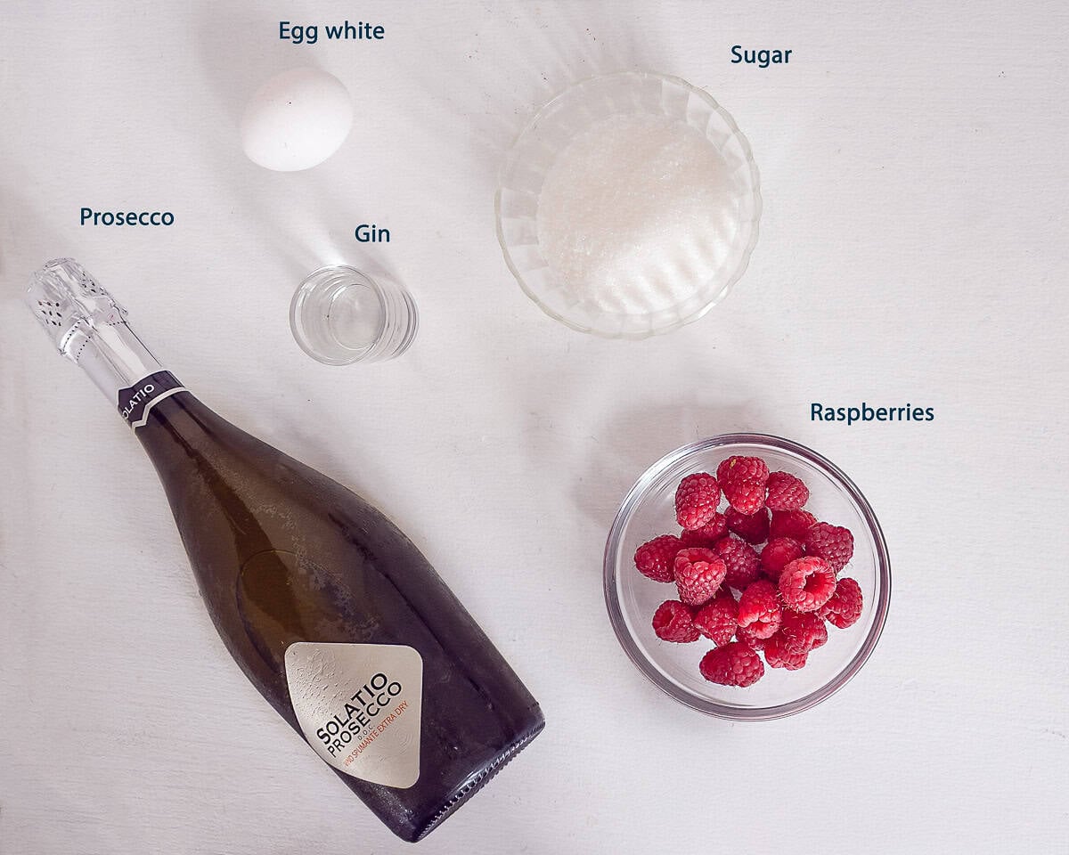 Ingredients Raspberry Gin Prosecco Cocktail on a white background with text description