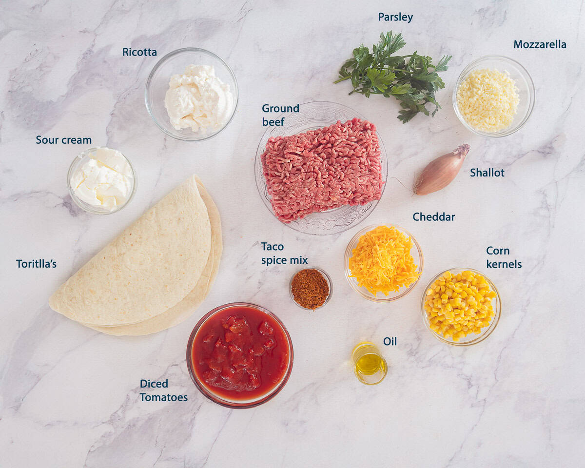 Ingredients Beef Taco Lasagna With Tortillas on a marble background with text description