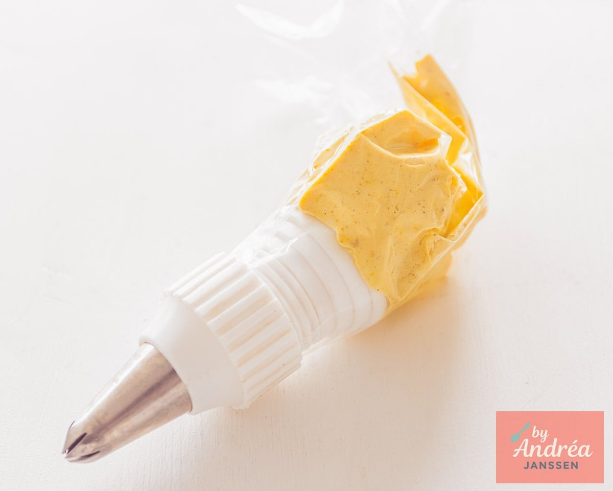 Put the filling for the deviled eggs in a piping bag