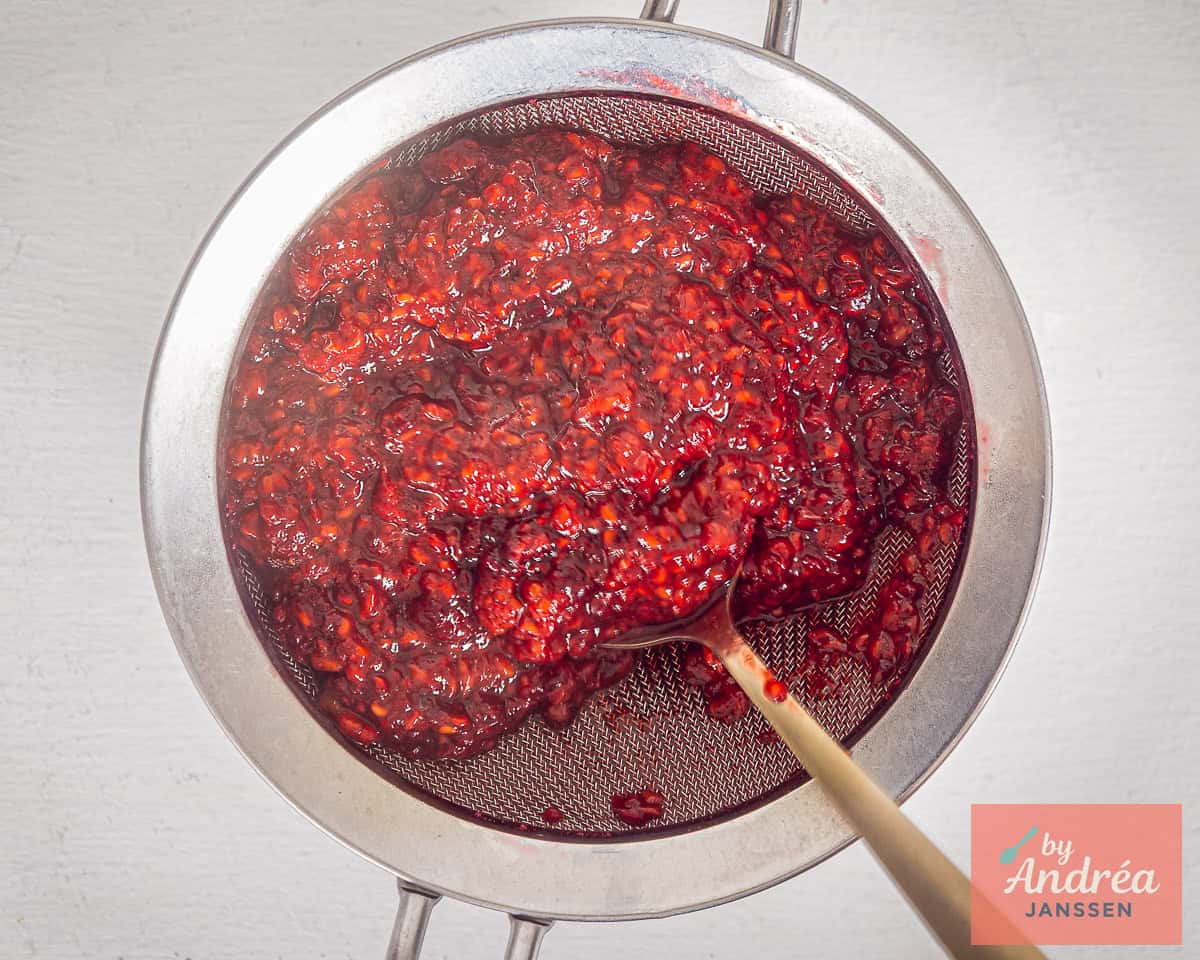 Raspberry pulp in a sieve
