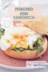 Part of a cut open bun on a pink plate topped with mayonnaise, poached egg and arugula. A text overlay at the top: poached egg sandwich, lunch, easy recipe.