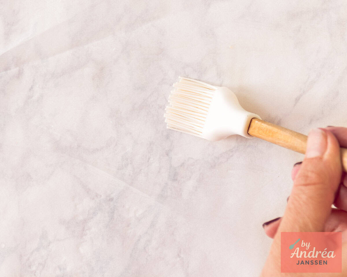 A baking sheet is greased with oil