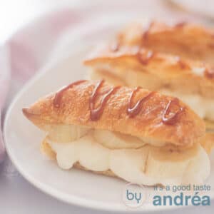 A square photo with three napoleons in a row filled with whipped cream and with caramel sauce