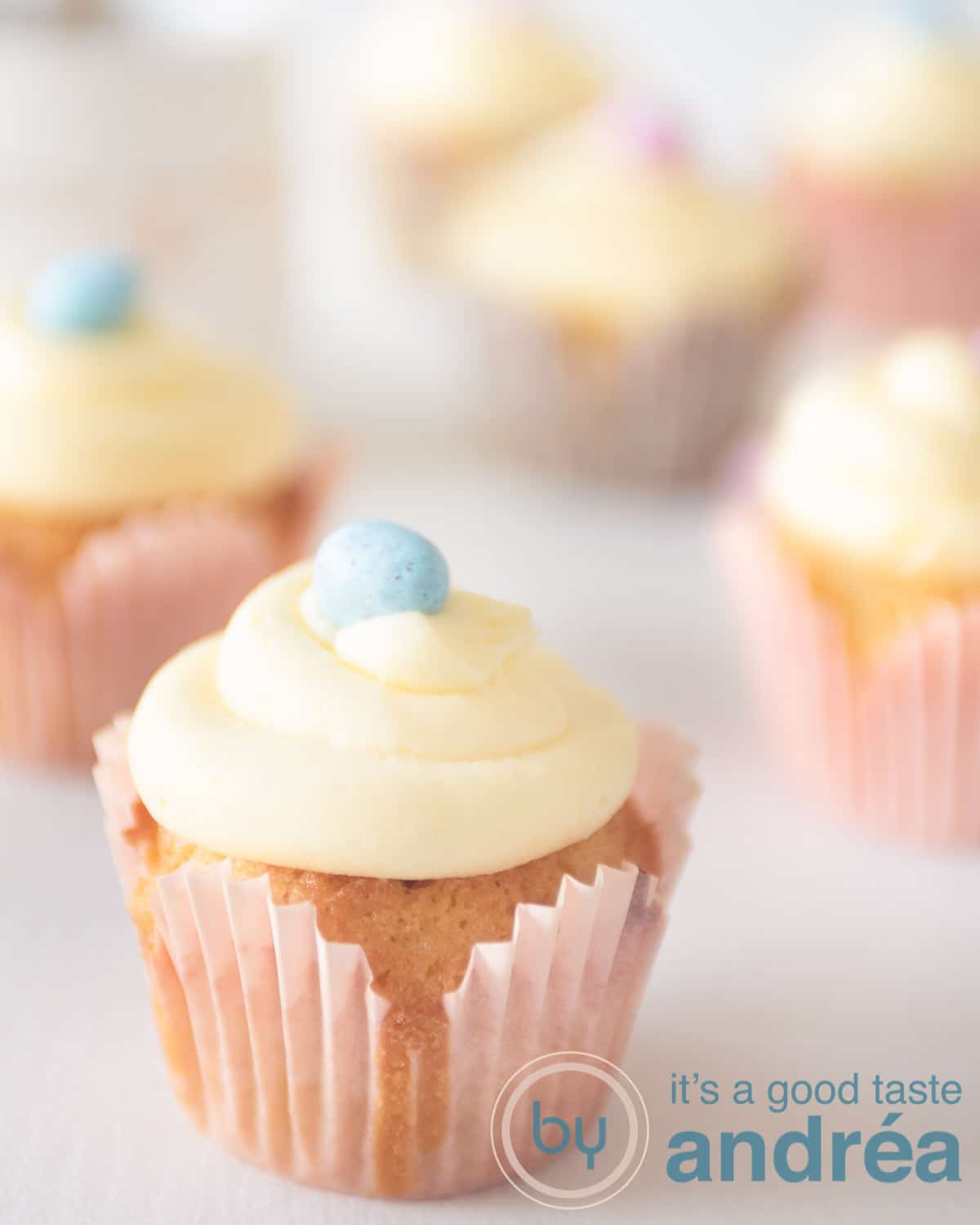 six cupcakes, one in front. Topped with buttercream and a chocolate egg