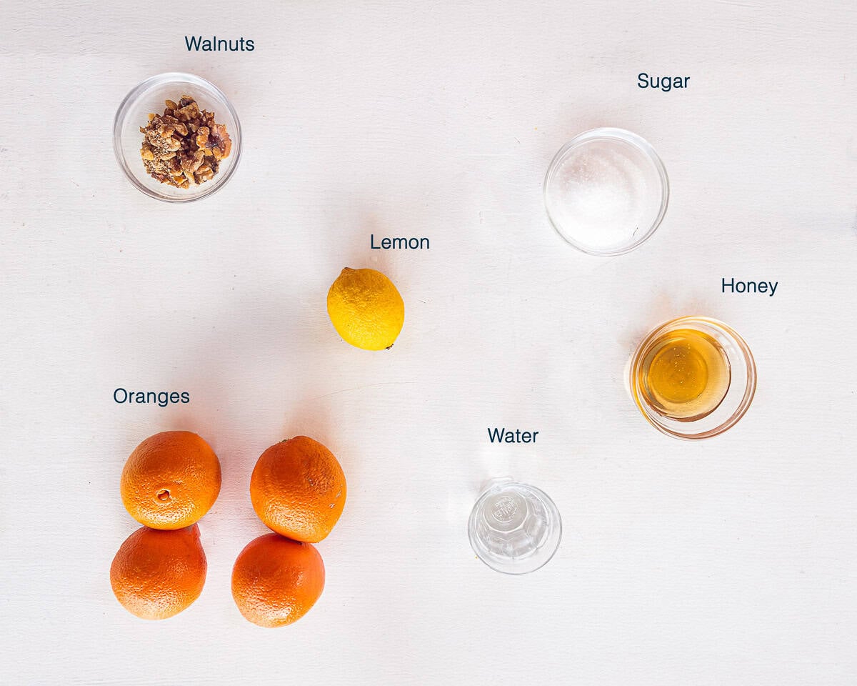 Ingredients Oranges with Honey and Walnuts (Easy Fresh Dessert) on a white background with text description