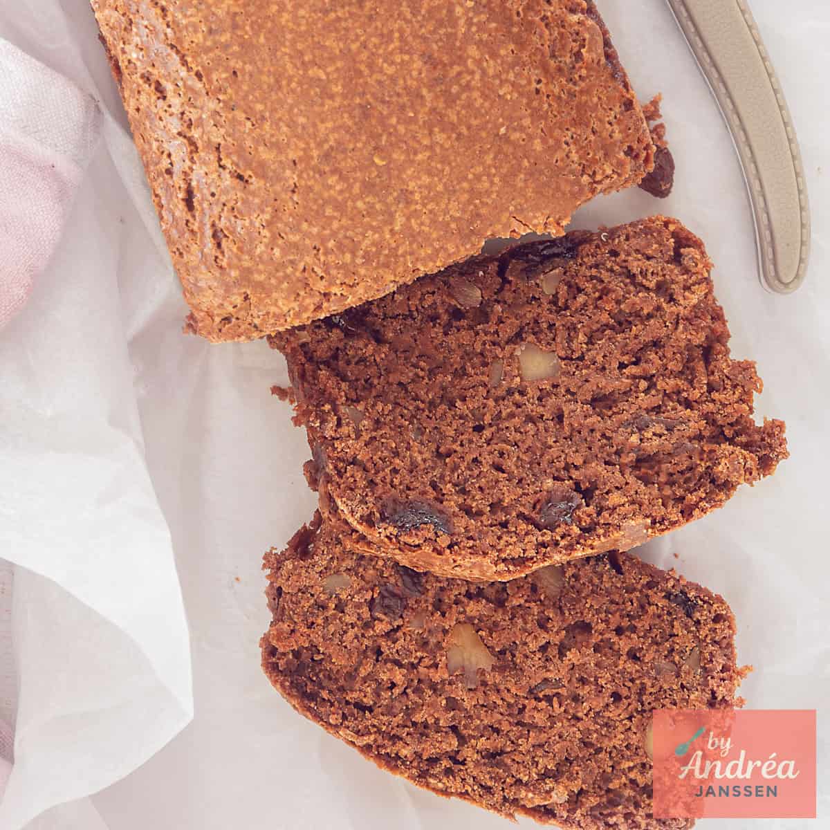 A square photo from above of a gingerbread with currants and walnuts