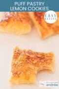 A few lemon cookies with almonds. A bite from the front cookie. A text at the top: puff pastry lemon cookies, easy recipe