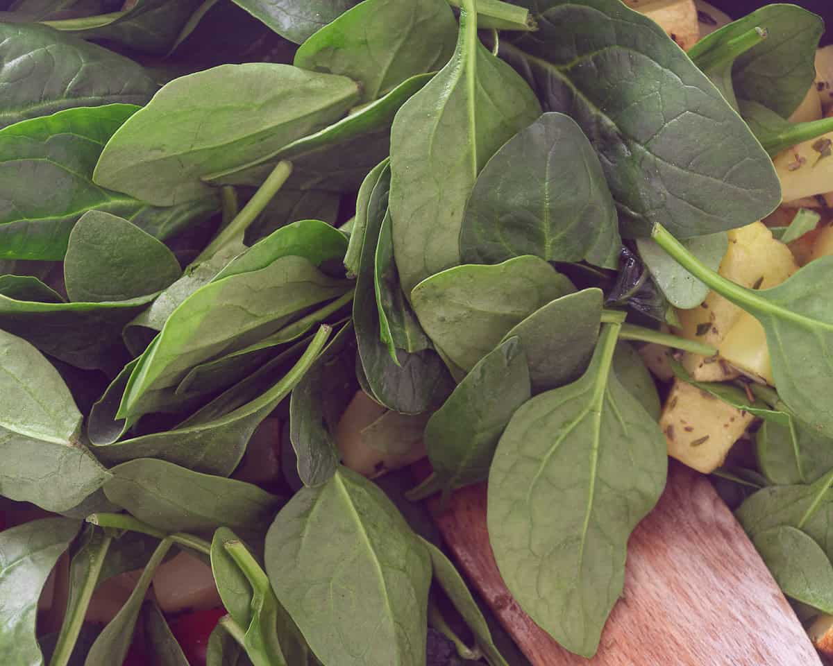 Spinach added to a pan with potatoes