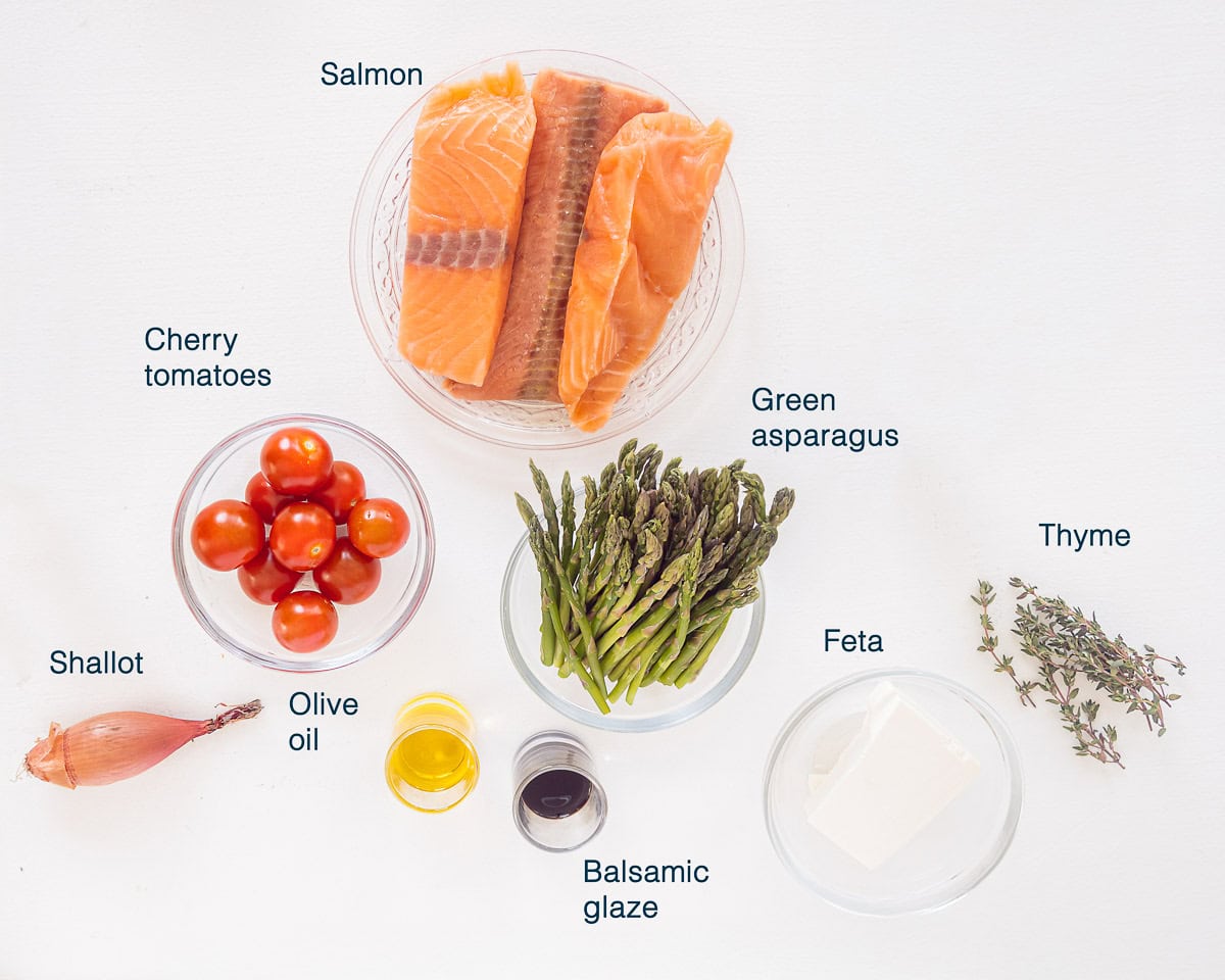 Ingredients Oven Baked Salmon with Asparagus and Cherry Tomatoes a white background and text description