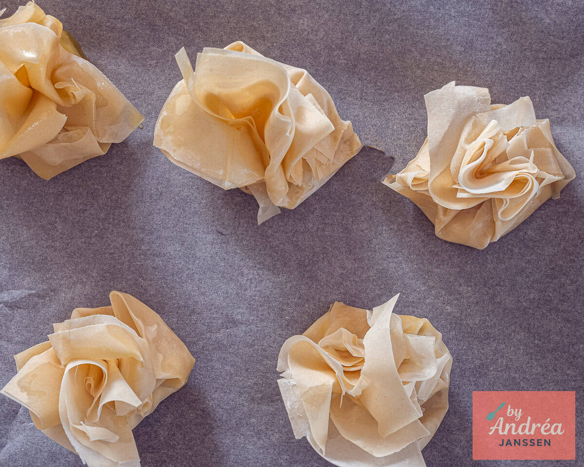All phyllo dough appetizers on a baking plate ready to be baked