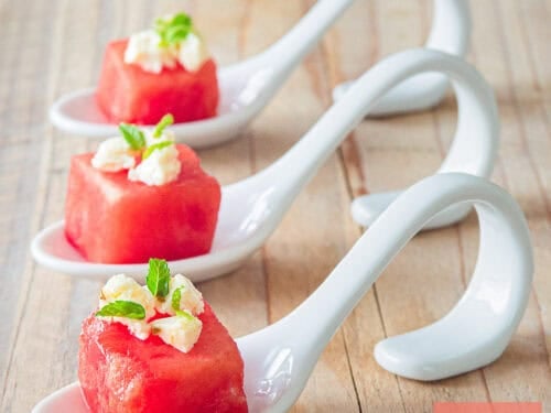 A square picture with three amuse-bouche watermelon with feta and mint