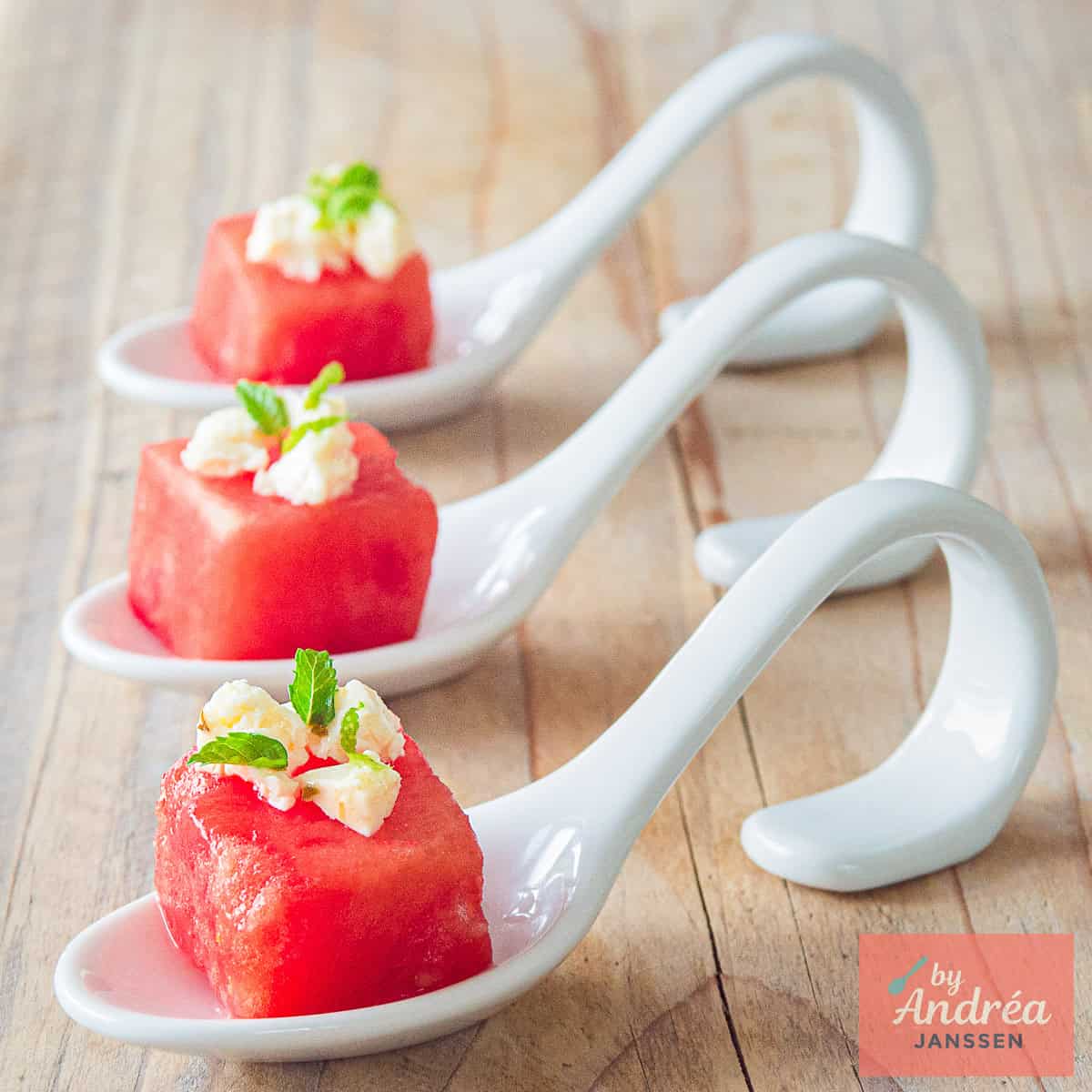 A square picture with three amuse-bouche watermelon with feta and mint