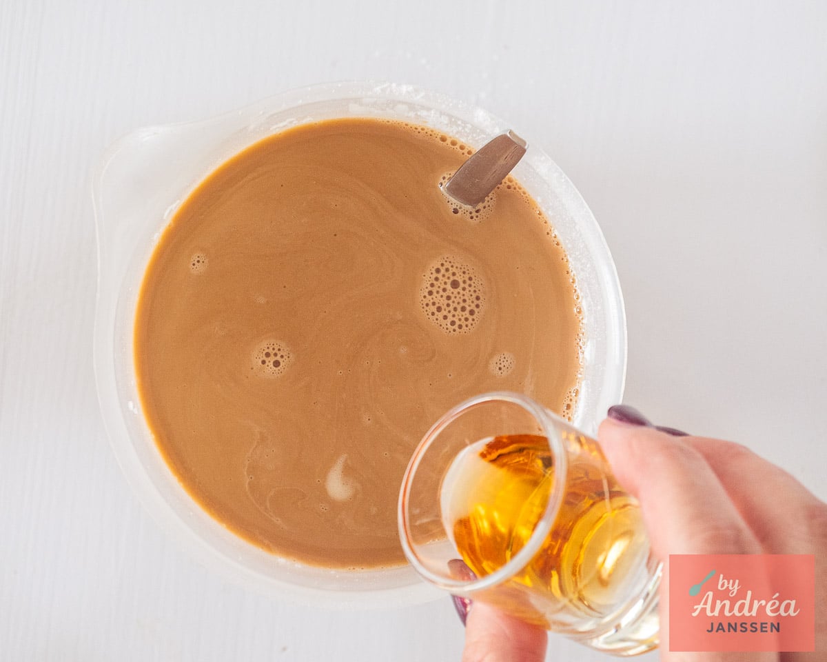 Amaretto being added to the coffee and cream mixture, an optional ingredient