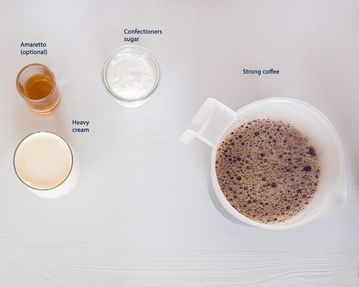 Ingredients for creamy iced coffee: strong coffee, heavy cream, confectioners sugar and amaretto (optional)