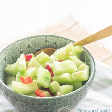 a green bowl with cucumber, pepper and garlic