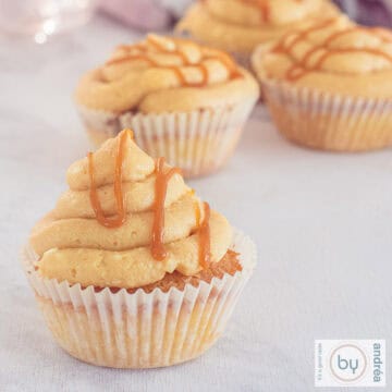 A square picture with cupcakes with caramel frosting and salted caramel drippings