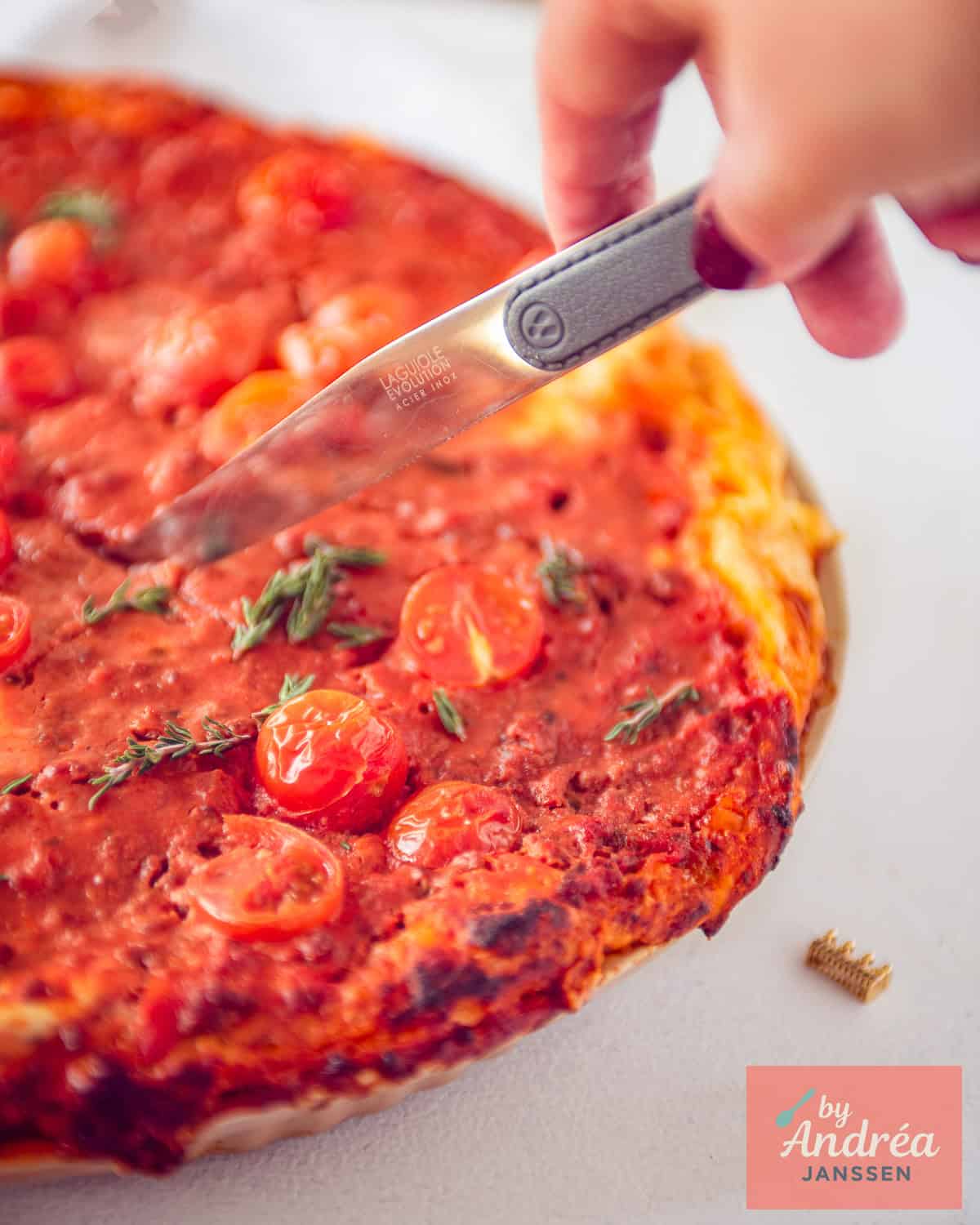 Half a Bolognese quiche from which a slice is cut.