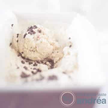 A square photo with a pink cake tin with chocolate honey ice cream. A scoop of ice cream on top.
