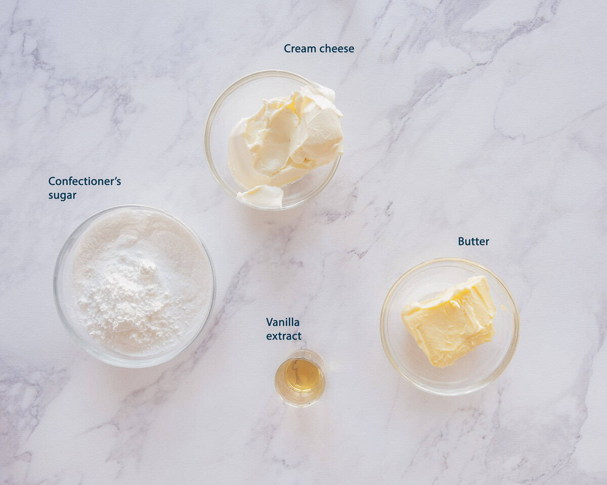 Ingredients cream cheese frosting on a white marble background with text description