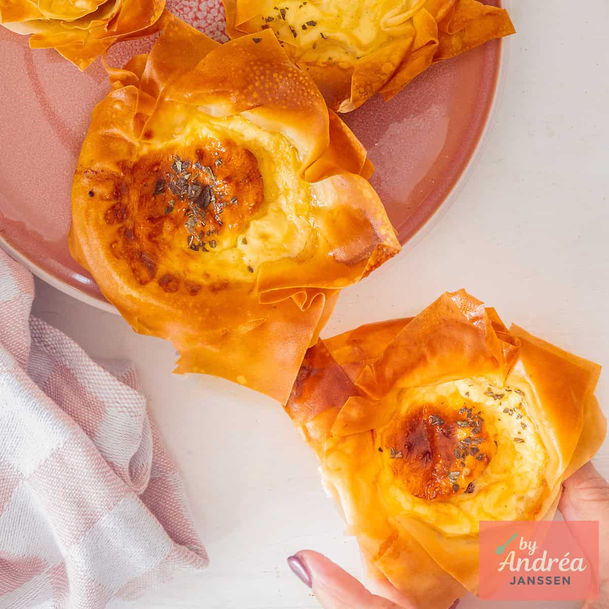 A square picture taken from above with mini quiche Lorraines.