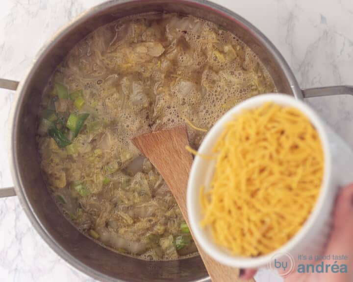 A bowl of vermicelli added to a cabbage leek soup.