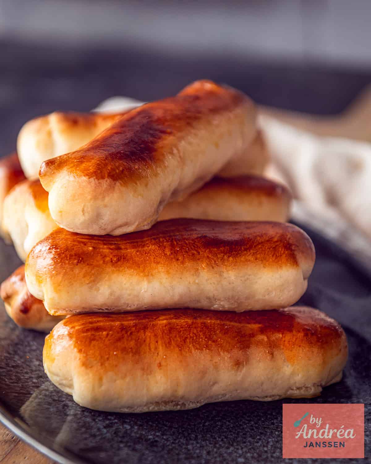 A grey plate with a stack of Dutch worstenbroodjes