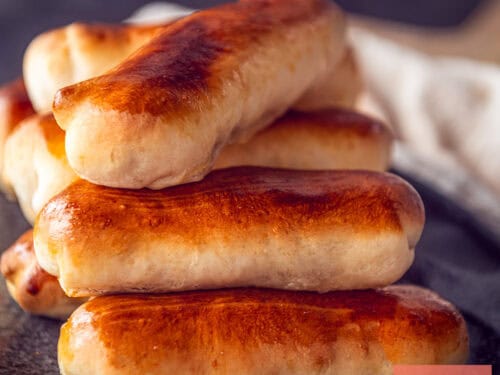 A square picture with a part of a plate with Brabantse worstenbroodjes