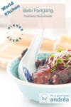 A blue bowl filled with babi pangang and sweet tomato sauce. A Chinese spoon is added to the bowl.