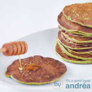 a square photo with pancakes filled with spinach. A pancake is topped with honey