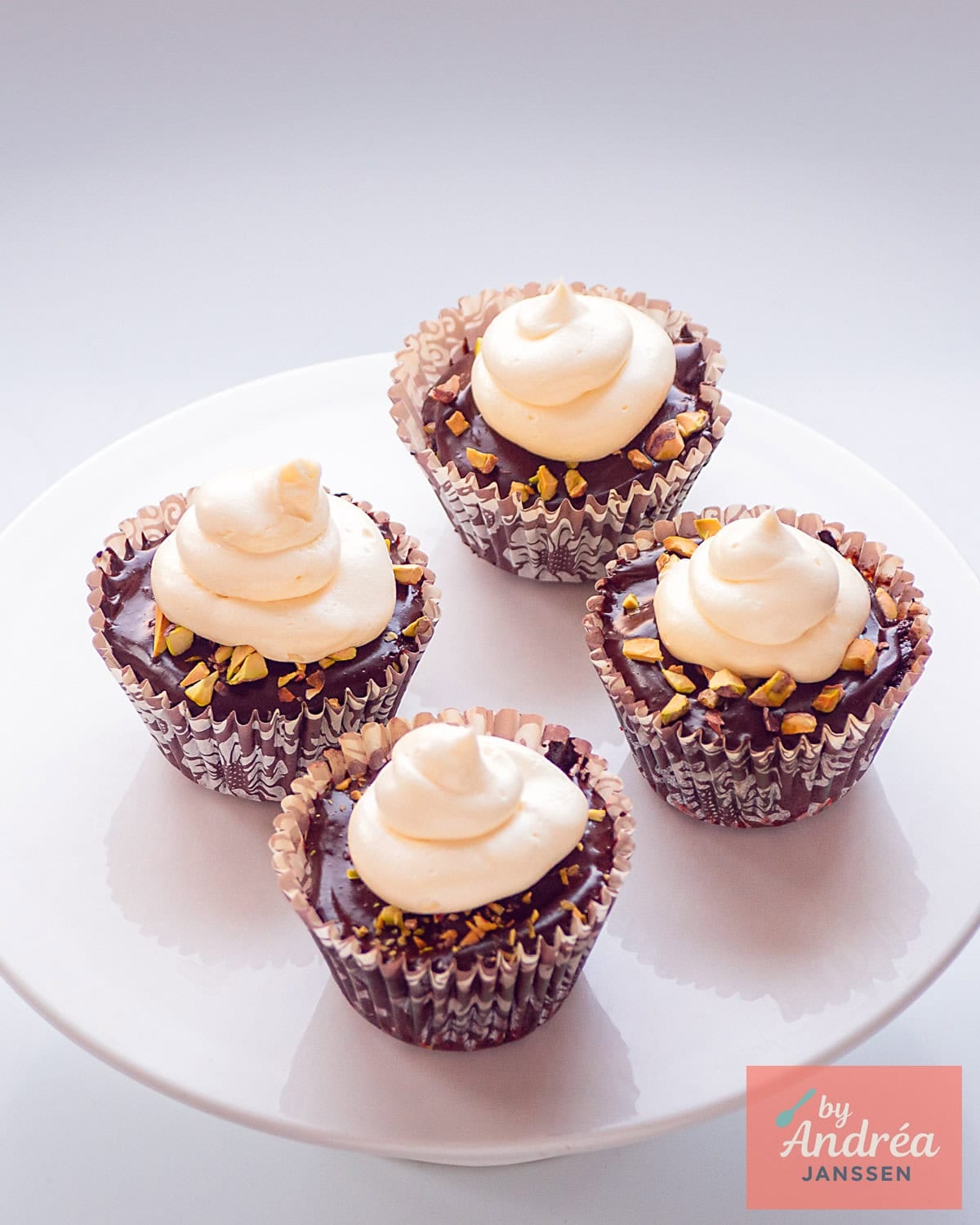 Een hoogtefoto met 4 drie chocolade cupcakes op een taartplateau