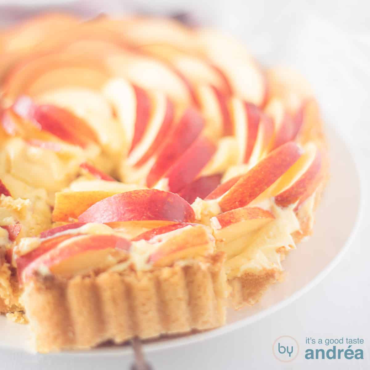 A square photo with part of an apple rose cake, one point cut out. A white background