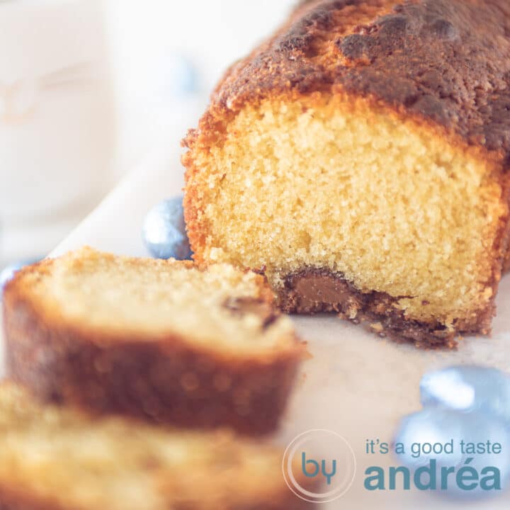 A part of a mini egg pound cake, two slices cut off on a wooden board