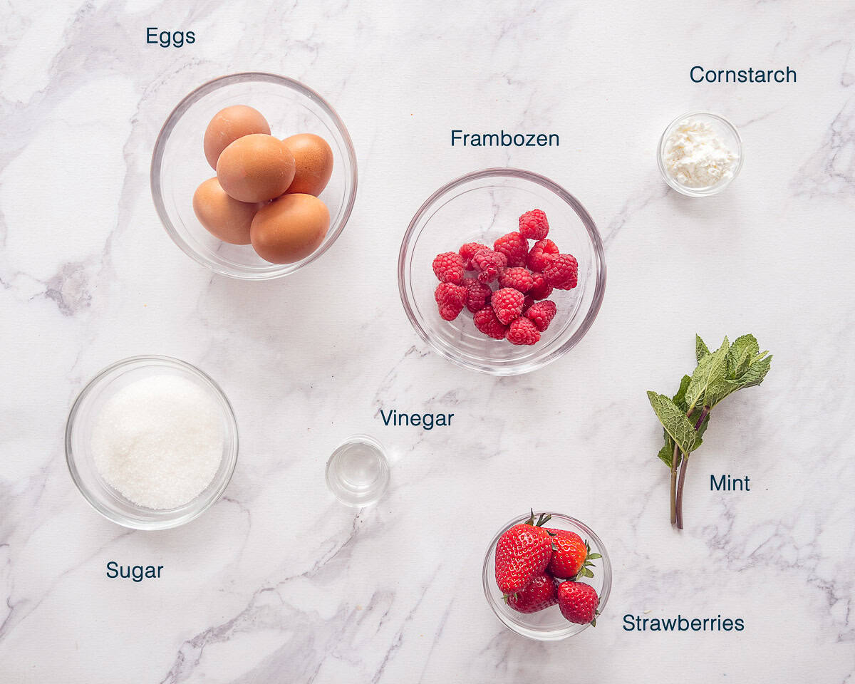 Ingredients Pavlova Recipe with Red Fruit and Whipped Cream on a white marbled background with text description