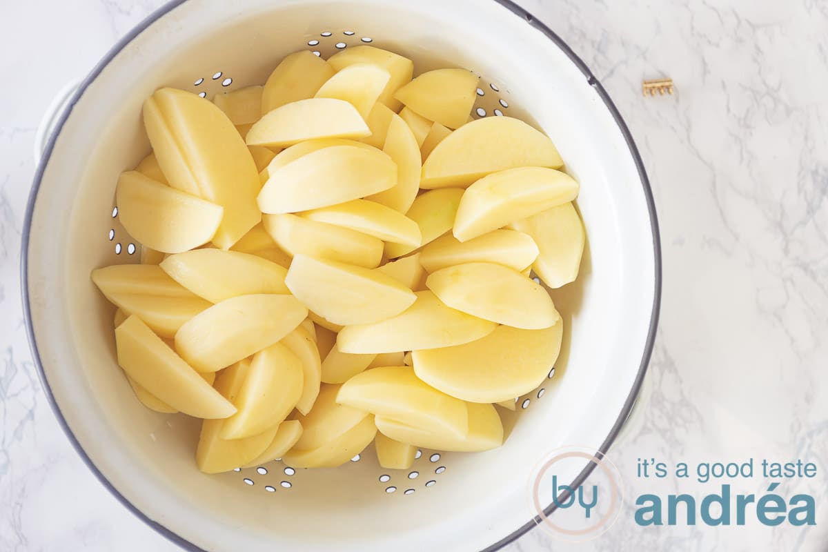 a colander with potato wedges