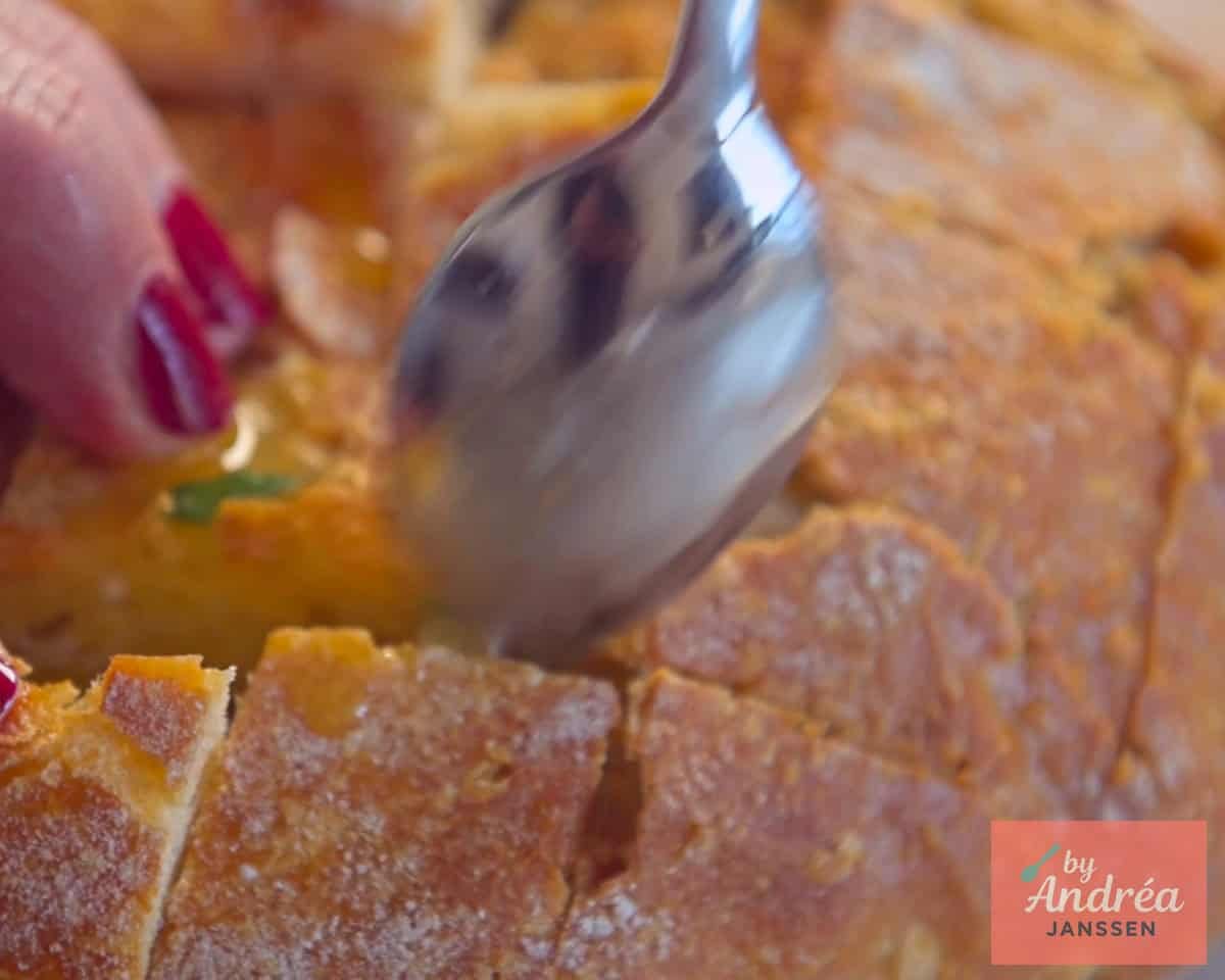 Spread the cut sides of the pull-apart bread with melted garlic butter
