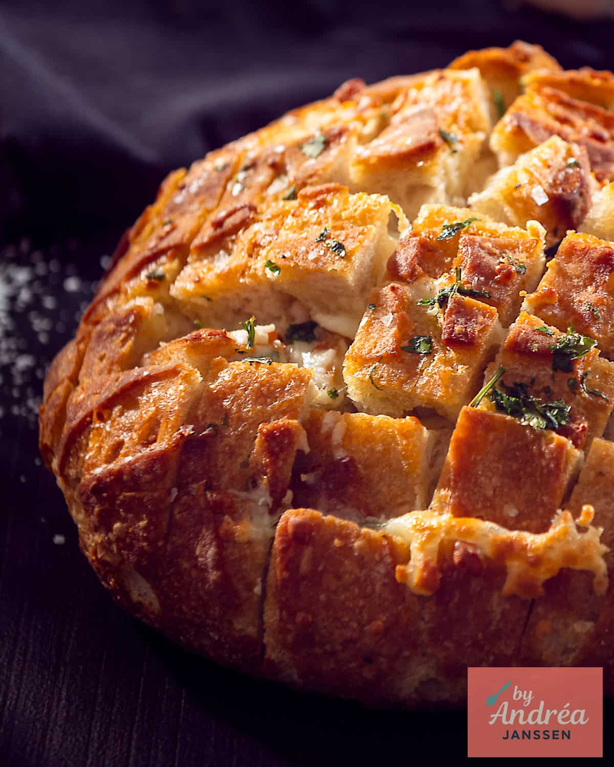 Pull-apart bread with a diamond cut pattern, garlic butter and mozzarella, ready to share