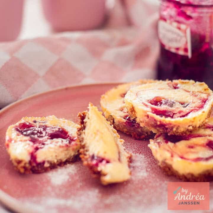 Creamy mini cheesecake cupcakes with a forest fruit swirl