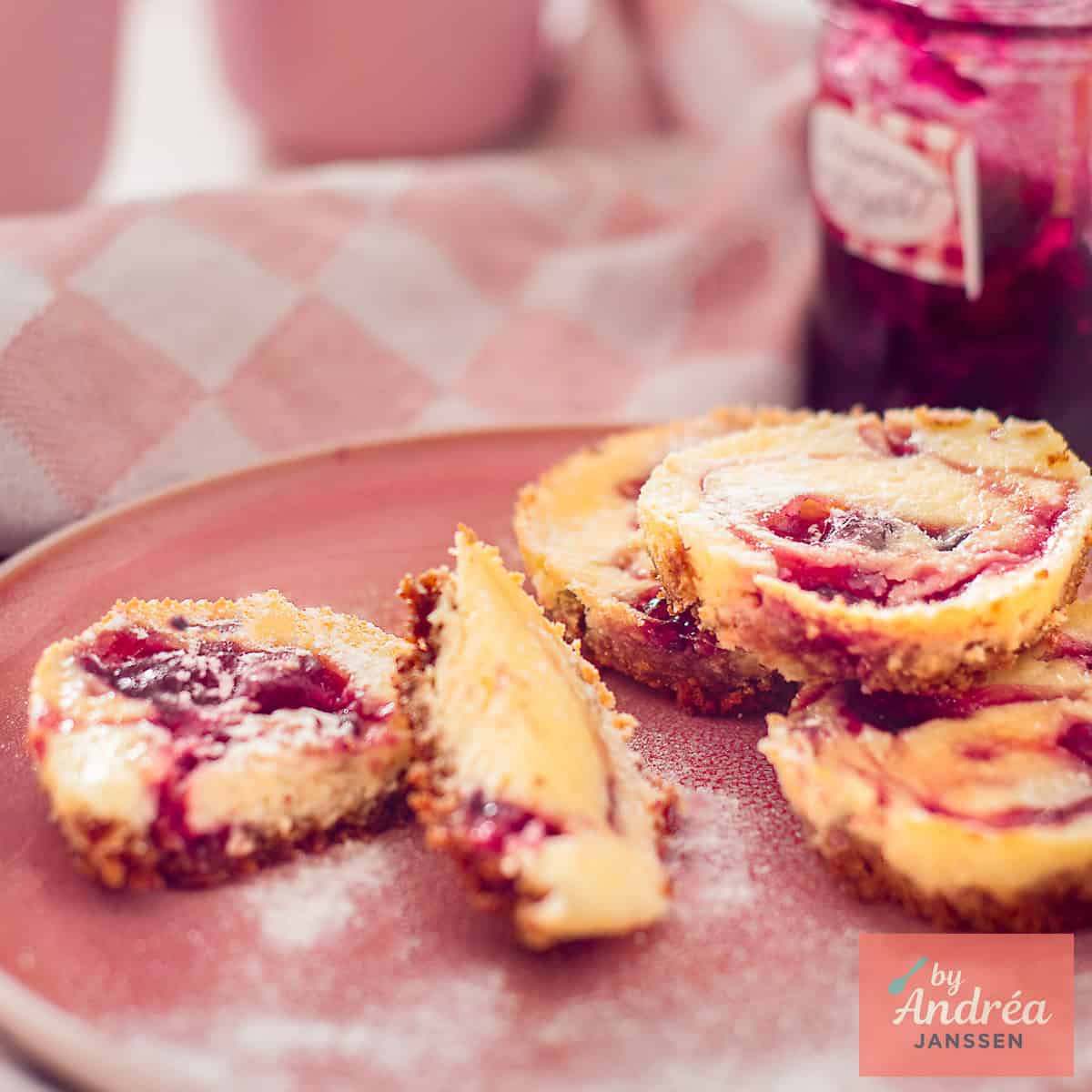 Creamy mini cheesecake cupcakes with a forest fruit swirl