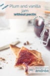 Two toasted slices of bread spread with plum jam. Two pots in the background.