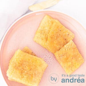 a square photo with a pink plate filled with cheddar cheese crackers