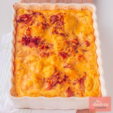 A square photo of an oven dish with cauliflower au gratin with bacon.