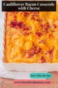 A white casserole dish filled with cauliflower, cream sauce, bacon, and cheese. A text at the top reads: Cauliflower Bacon Casserole with Cheese.
