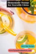 Homemade orange iced tea with lemon and lime wedges, mint and ice cubes in a glass. A text above: Homemade Orange Ice Tea with Citrus